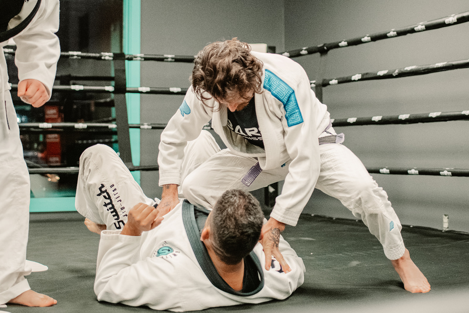 Two students grappling in the ring at Switch Fitness San Diego.